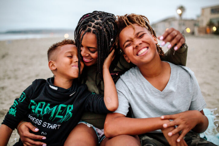 mom and sons on beach