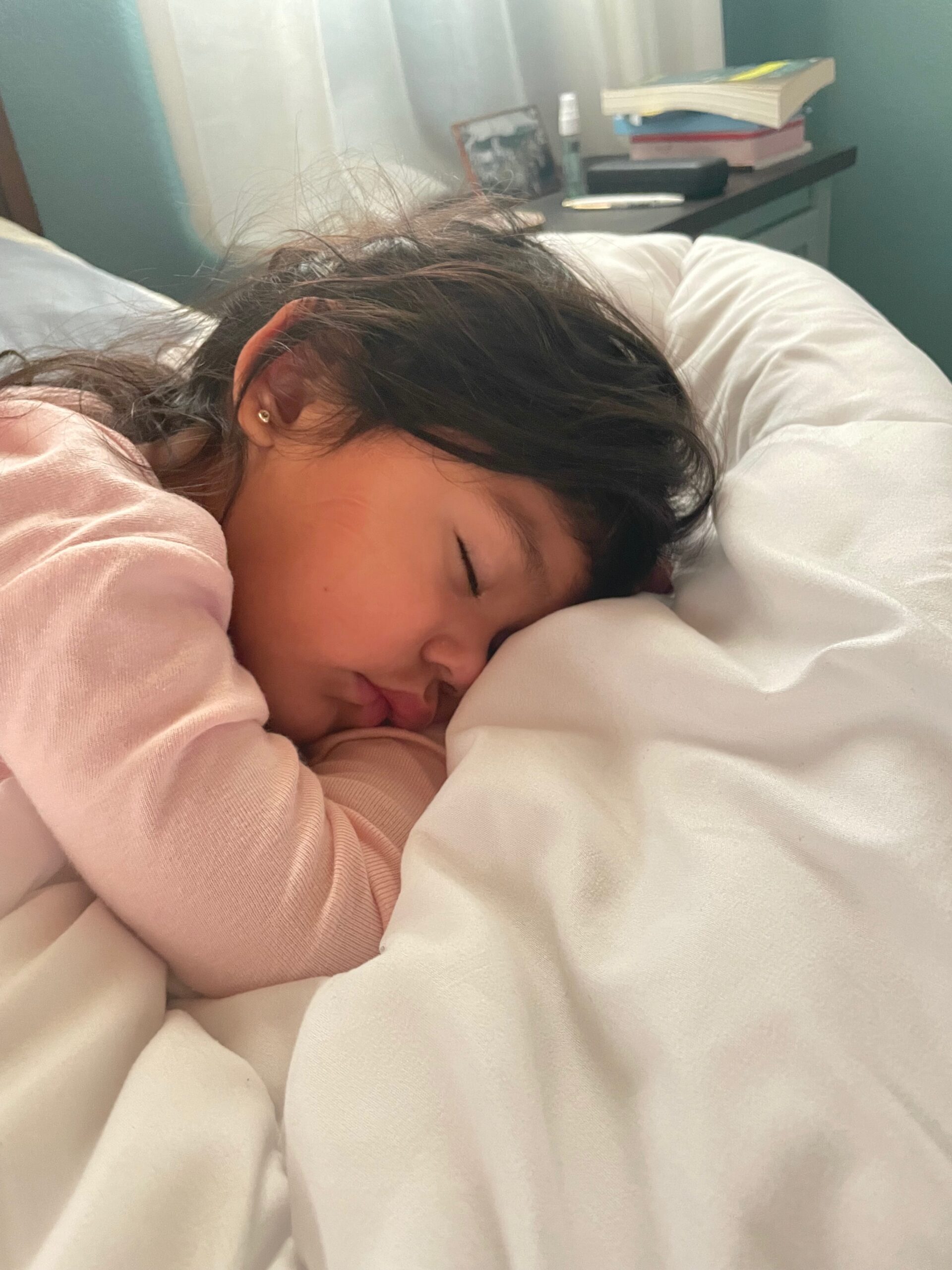 toddler sleeping on bed